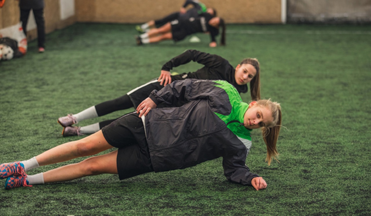 Soccer player performing strength training exercises to prevent soccer injuries and improve performance.